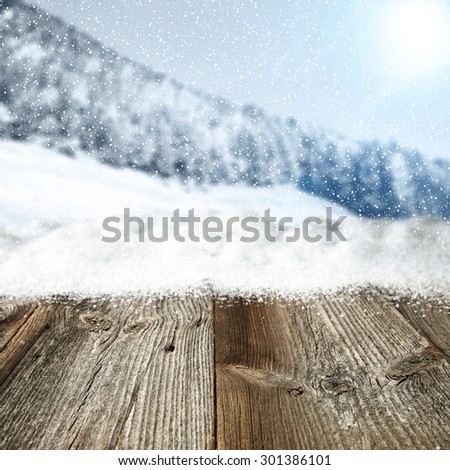 retro worn gray wooden table snow and free place for you with xmas blurred background