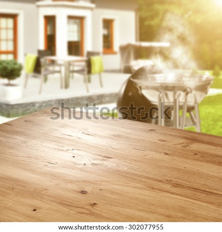 blurred background of grill in garden and yellow desk space