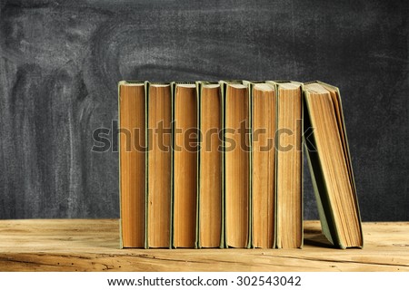 brown books in class and chalkboard