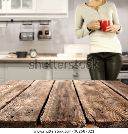 vintage old table of brown color and woman with red mug with gray cloths