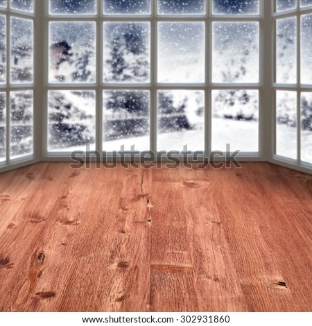 blurred background of window with winter landscape and big red window sill
