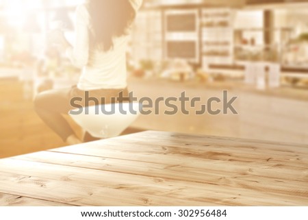 blurred background of bar with woman on chair and yellow board and sun