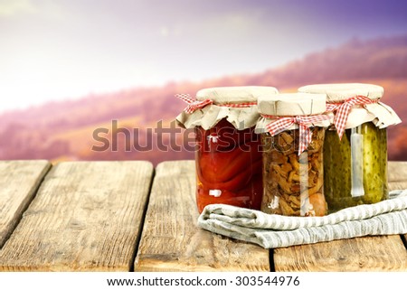 three jars on table place and autumn day