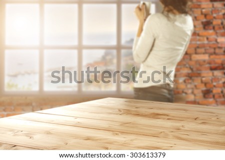 blurred background of wall of red color and white window and wooden desk space and cafe space