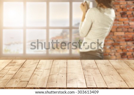 blurred background of wall of red color and white window and woman with mug