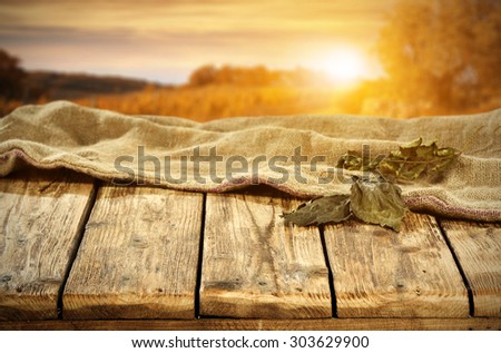 autumn sunset and landscape with leaves of autumn on top