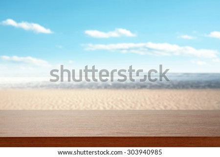 brown board and sea with sky and sand
