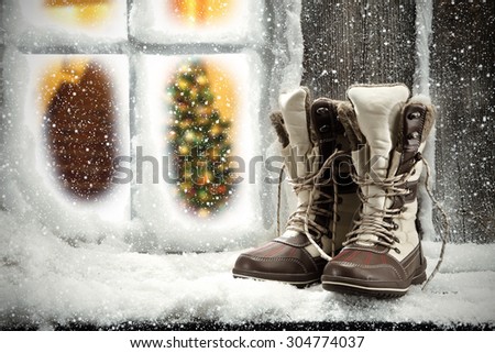 shoes on window sill of snow and xmas tree in home space