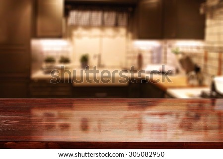 blurred background of red kitchen interior and wooden glasses red board