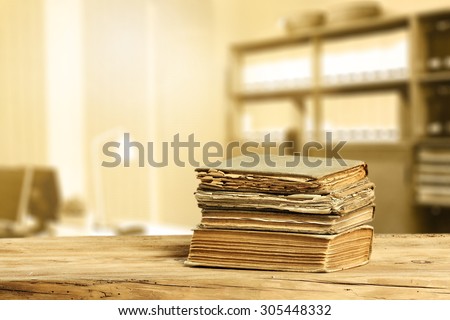 literature on desk of wood and interior of office