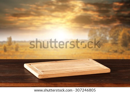 blurred background of autumn sunset and landscape with golden trees with wooden kitchen desk space