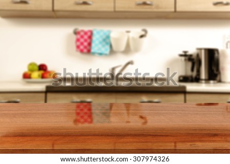 blurred background of kitchen interior and glasses desk top of brown color