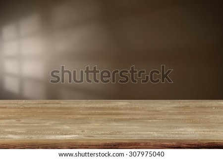 blurred brown wall with shadow space of window and gray wooden desk space