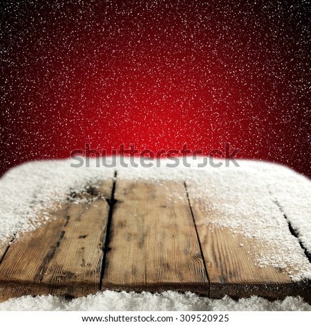 big wooden table place of snow and red wall place