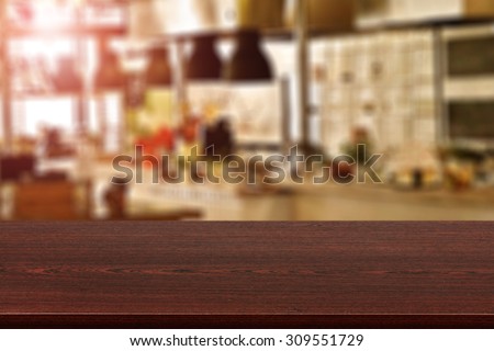 blurred background of kitchen room with red flare and board place of wood and space for you