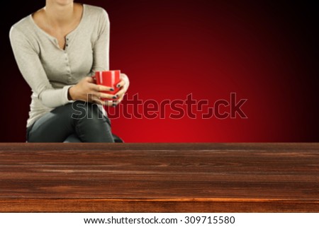 brown desk red wall and red mug