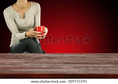 dirty dark red desk and woman with red mug