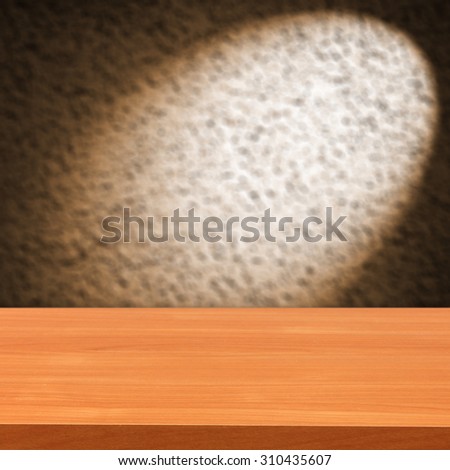 blurred brown background of wall with shadow of lamp and desk space and red color
