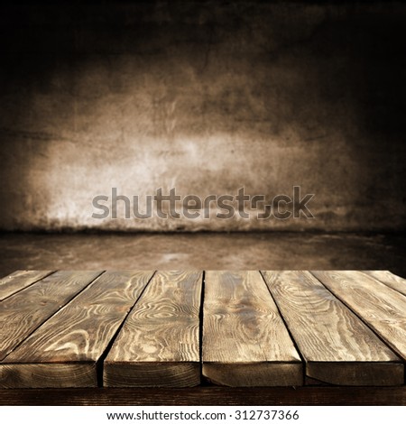 dark blurred wall of brown color and dark shadows with desk top place