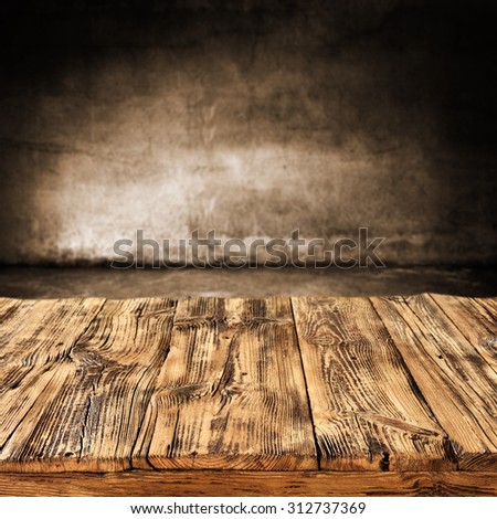 dark blurred wall of brown color and dark shadows with wooden desk