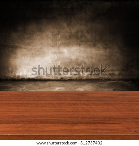 dark blurred wall of brown color and dark shadows with desk