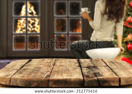 blurred background of xmas tree and window with xmas tree on street with worn old table place
