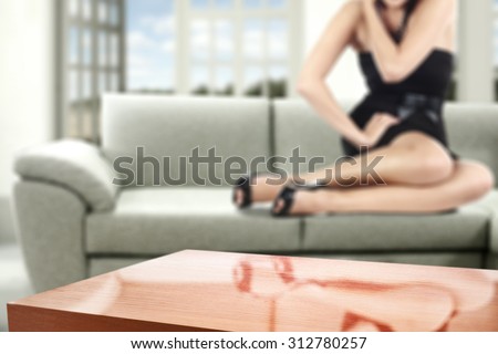 gray sofa with woman in black dress and red table and free space