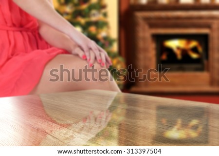 woman in red dress fire place and wooden table