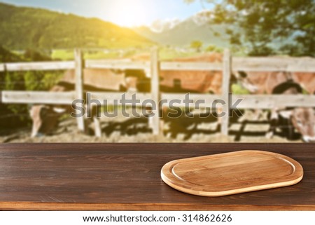 desk top of wood wooden board and cows landscape
