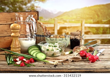 sunny morning time with landscape of cows and breakfast food and wooden old board place