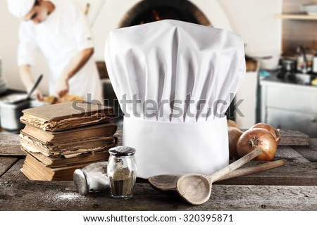 interior of fireplace and cook with pizza and decoration of chef hat