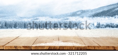 wooden yellow desk top snow and blue landscape