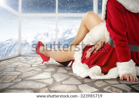 santa claus woman on stone gray retro floor with background of white window and snow