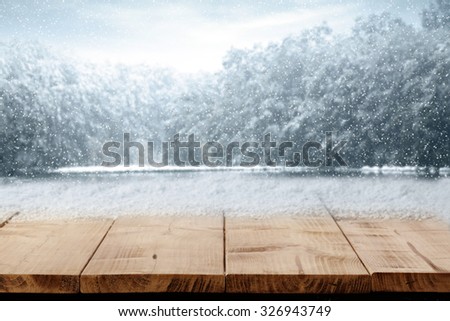 blurred background of winter and gray trees and xmas table of free space