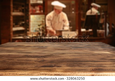 dark interior of restaurant with kitchen chef and wooden board