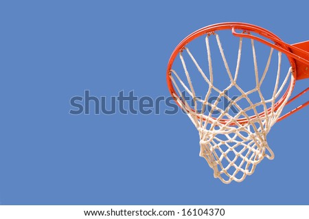 Basketball backboard hoop and net against a blue sky