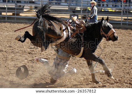APACHE JUNCTION, AZ - FEBRUARY 28: A competitor is thrown from a bucking horse in the saddle bronc competition at the Lost Dutchman Days Rodeo on February 28, 2009 in Apache Junction, AZ.