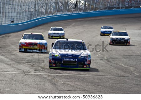 AVONDALE, AZ - APRIL 10: Jimmie Johnson (#58) leads a group of cars out of turn two at the Subway Fresh Fit 600 NASCAR Sprint Cup race on April 10, 2010 in Avondale, AZ.