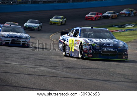 AVONDALE, AZ - APRIL 10: Jimmie Johnson (#48) leads a group of cars out of turn one at the Subway Fresh Fit 600 NASCAR Sprint Cup race on April 10, 2010 in Avondale, AZ.