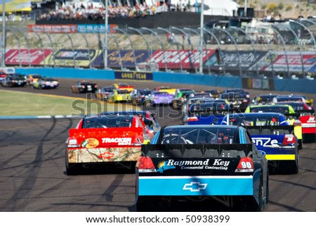 AVONDALE, AZ - APRIL 10: A group of cars drives through turn two at the Subway Fresh Fit 600 NASCAR Sprint Cup race on April 10, 2010 in Avondale, AZ.