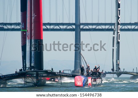 SAN FRANCISCO, CA - SEPTEMBER 12: Emirates Team New Zealand crew waves to crowd after winning their  America's Cup race in San Francisco, CA on September 12, 2013