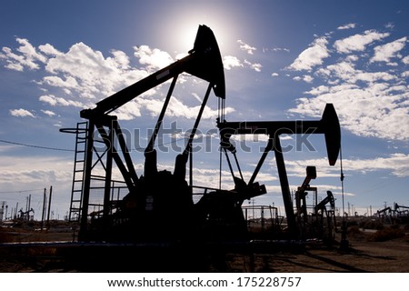 KERN COUNTY, CALIFORNIA - NOVEMBER 26, 2013: Pumpjacks extract oil from an oilfield in Kern County, CA. About 15 billion barrels of oil could be extracted using hydraulic fracturing in California.