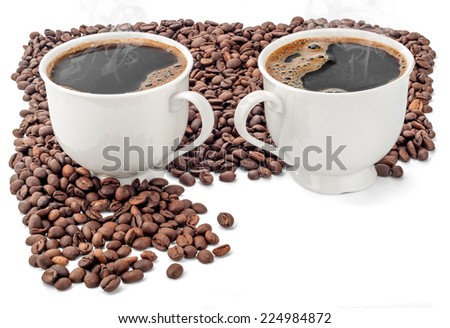 Two cups of coffee surrounded by coffee beans on white background. Extended Depth of Field and useful Copy Space in the lower right corner.