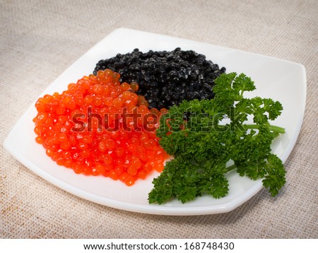 red and black caviar is in a serving plate
