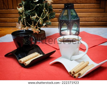 two cups of coffee and wafer sticks with chocolate
