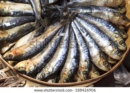 Whole smoked sardines presented in a lovely circular way for sale at the Mercado Central in Valencia, Spain.