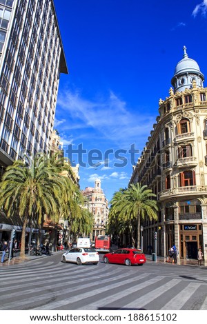 VALENCIA, SPAIN - APRIL 4 : Center of Valencia city with Bank of Valencia, big buildings and cars and people moving around on April 4th, 2014 in Valencia, Spain