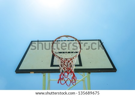 Basketball basket on summer blue sky.