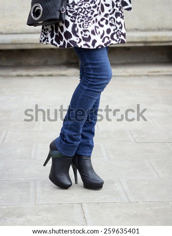 Girl\'s leg with black boots on a high heel