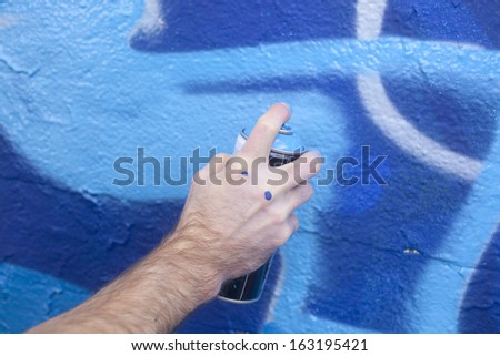 Hand Holding a Spray Paint Can